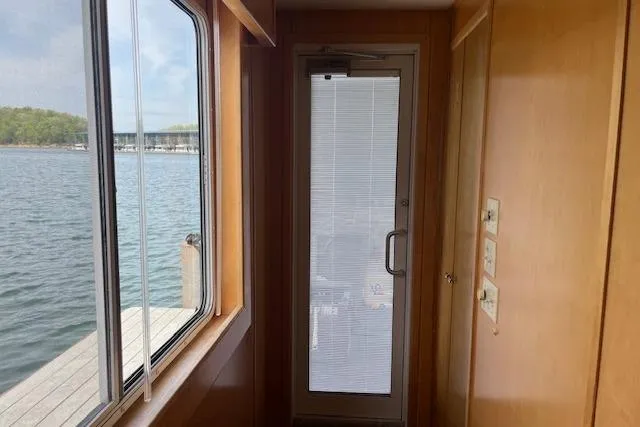 Slide: The Image of Interior view of a 2003 Fantasy 18x80 Houseboat with lake view through window. - 27