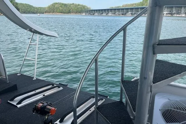 Slide: The Image of 2003 Fantasy 18x80 Houseboat with slide and spiral staircase on a serene lake. - 28