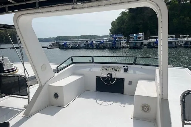 Slide: The Image of 2003 Fantasy 18x80 Houseboat helm with marina view in the background. - 32