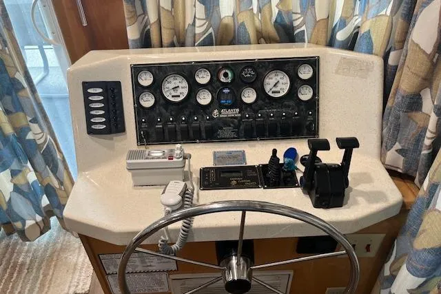 Slide: The Image of Control panel of a 2003 Fantasy 18x80 Houseboat with steering wheel and gauges. - 5