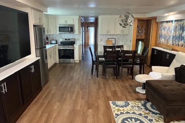 Slide: The Image of Interior of a 2003 Fantasy 18x80 Houseboat with modern kitchen and dining area. - 6