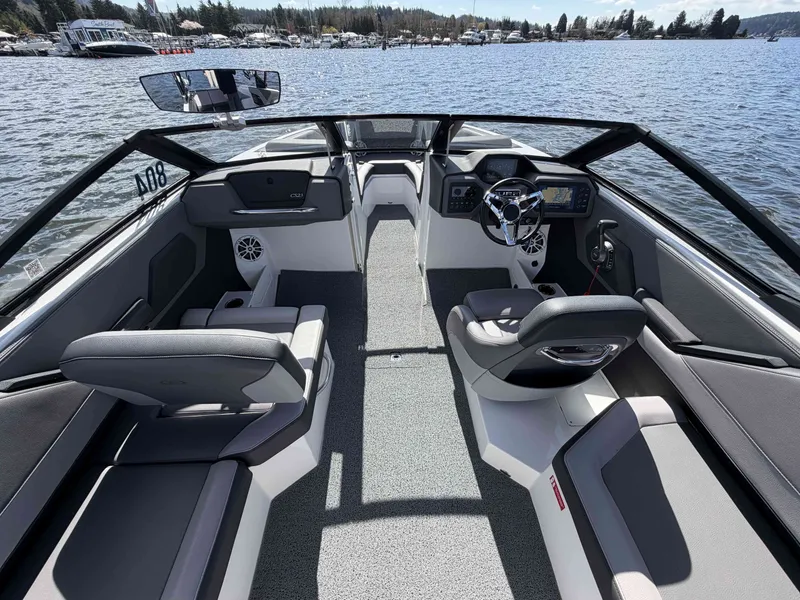 Slide: The Image of Interior of 2025 Cobalt CS23 Surf with stylish seating by the water. - 15