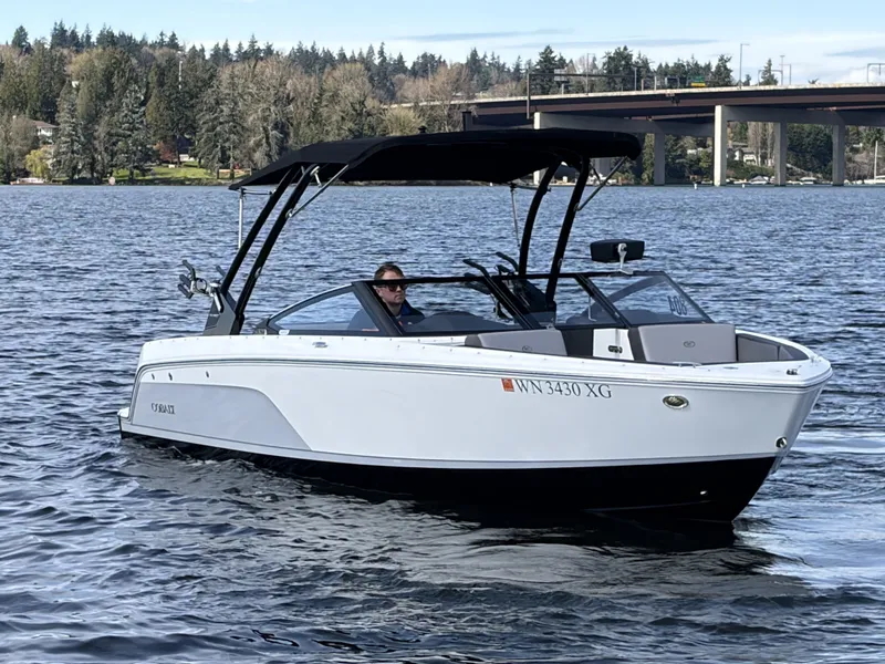 Slide: The Image of 2025 Cobalt CS23 Surf boat on a calm lake. - 3