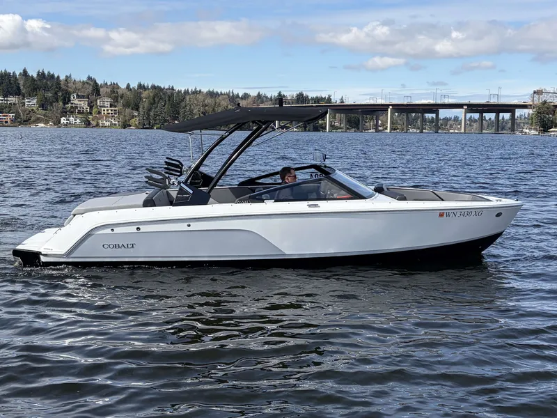 Slide: The Image of 2025 Cobalt CS23 Surf boat on a calm lake. - 5