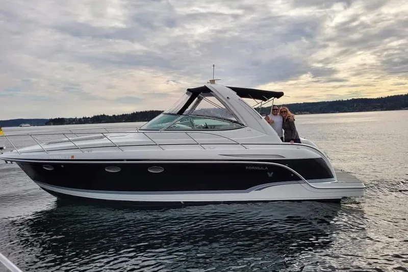 Slide: The Image of 2007 Formula 34 Performance Cruiser on calm water with two people onboard. - 1