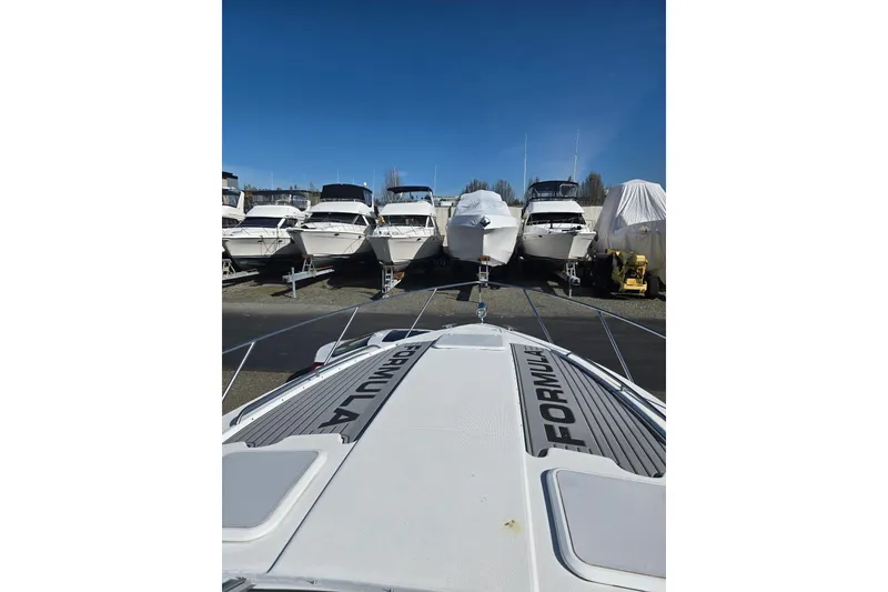 Slide: The Image of 2007 Formula 34 Performance Cruiser in storage, surrounded by other boats under clear blue sky. - 18