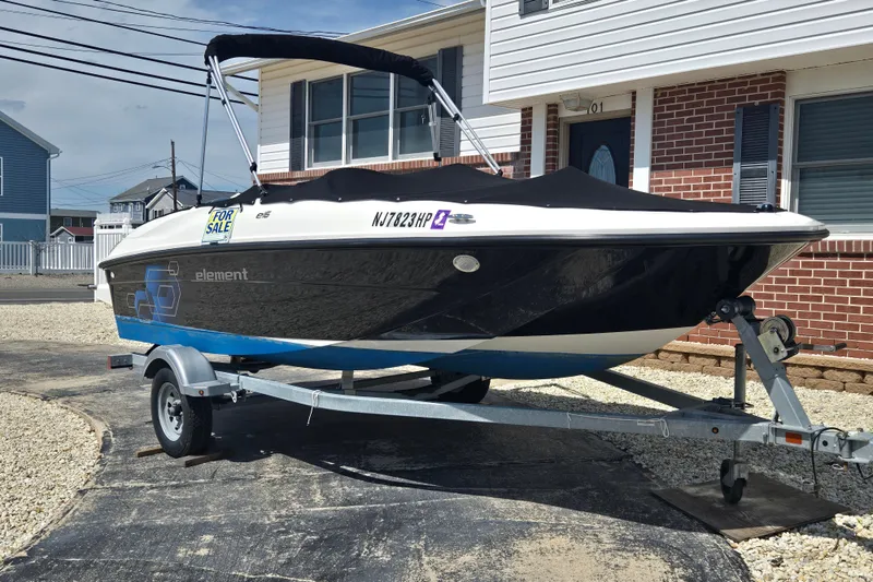 The Image of 2019 Bayliner Element E16 boat on trailer, for sale, parked in driveway. - 0