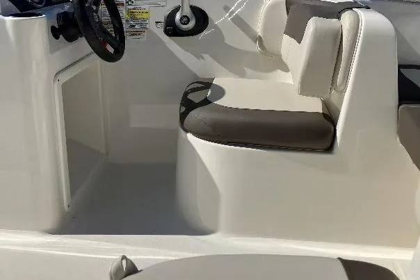 Slide: The Image of 2019 Bayliner Element E16 boat interior with seating and steering wheel. - 11