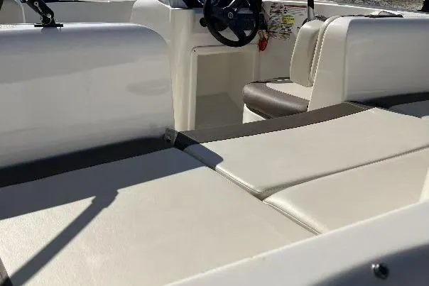 Slide: The Image of 2019 Bayliner Element E16 boat interior with seating and steering wheel. - 12