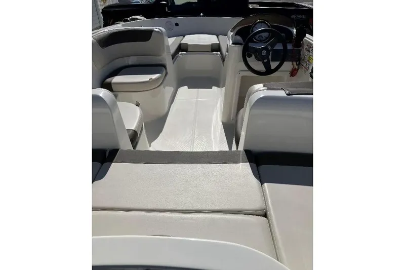 Slide: The Image of 2019 Bayliner Element E16 boat interior with seating and steering wheel. - 2