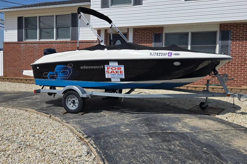 Slide: The Image of 2019 Bayliner Element E16 boat for sale on trailer in driveway. - 5