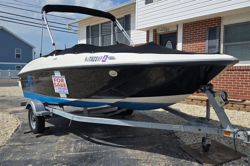 Slide: The Image of 2019 Bayliner Element E16 boat for sale on trailer, parked in driveway. - 6