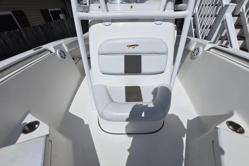 Slide: The Image of 2013 Tidewater 210 LXF boat interior with white seating and cup holders. - 10