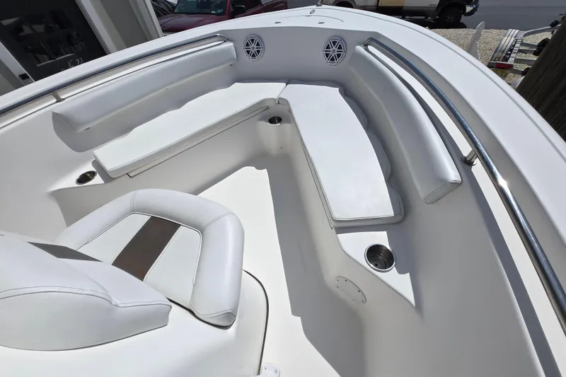 Slide: The Image of Interior view of a 2013 Tidewater 210 LXF boat with white seating and cup holders. - 12