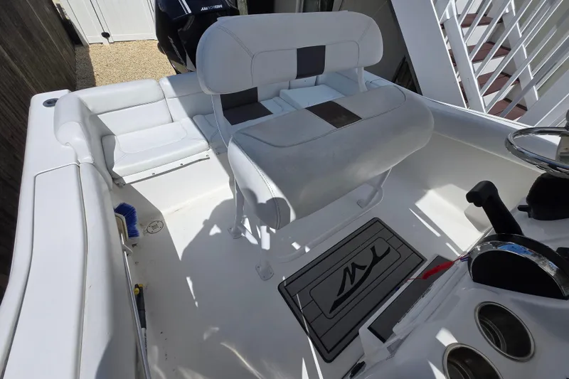 Slide: The Image of Interior of a 2013 Tidewater 210 LXF boat with seating and steering console. - 13