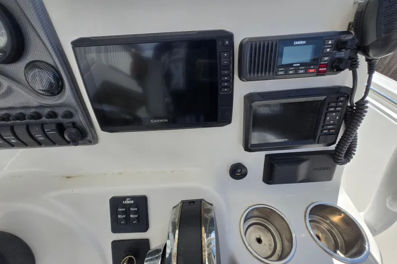 Slide: The Image of Control panel of a 2013 Tidewater 210 LXF boat with Garmin and Uniden electronics. - 16