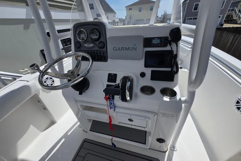 Slide: The Image of 2013 Tidewater 210 LXF boat console with Garmin navigation and steering wheel. - 2