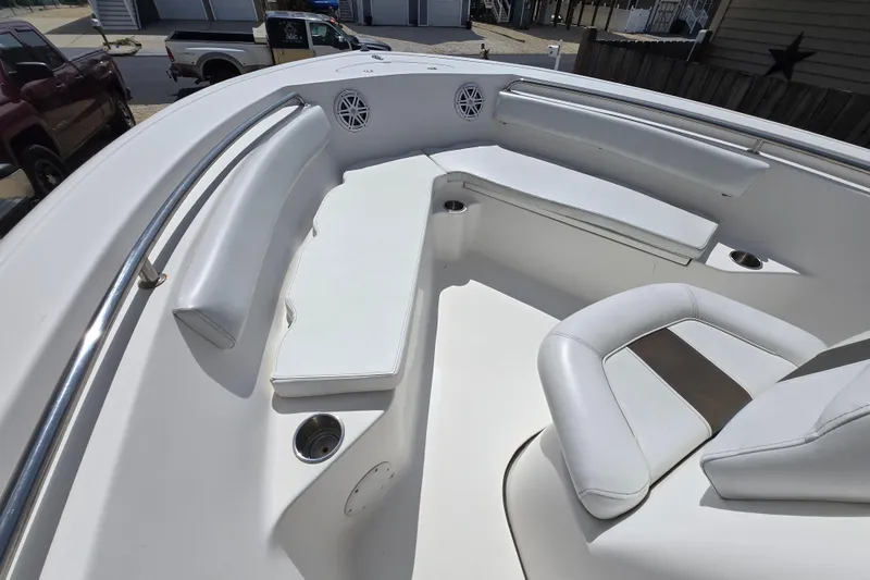 Slide: The Image of 2013 Tidewater 210 LXF boat interior with white seating and stainless steel railings. - 9