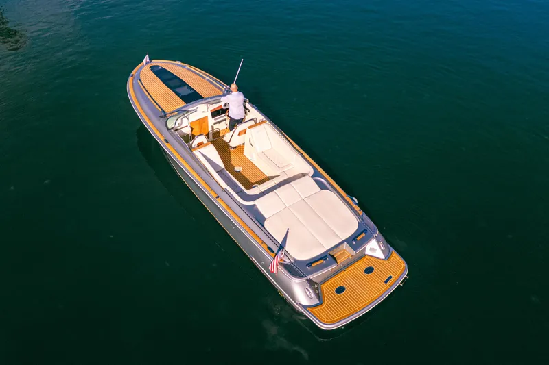 Slide: The Image of 2021 Chris-Craft Corsair 34 luxury boat cruising on calm blue waters. - 13