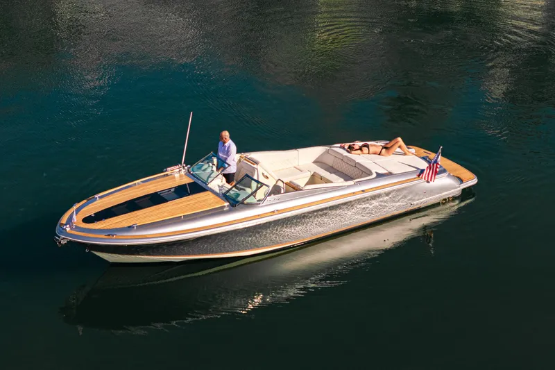 Slide: The Image of 2021 Chris-Craft Corsair 34 luxury boat cruising on calm water with passengers. - 14