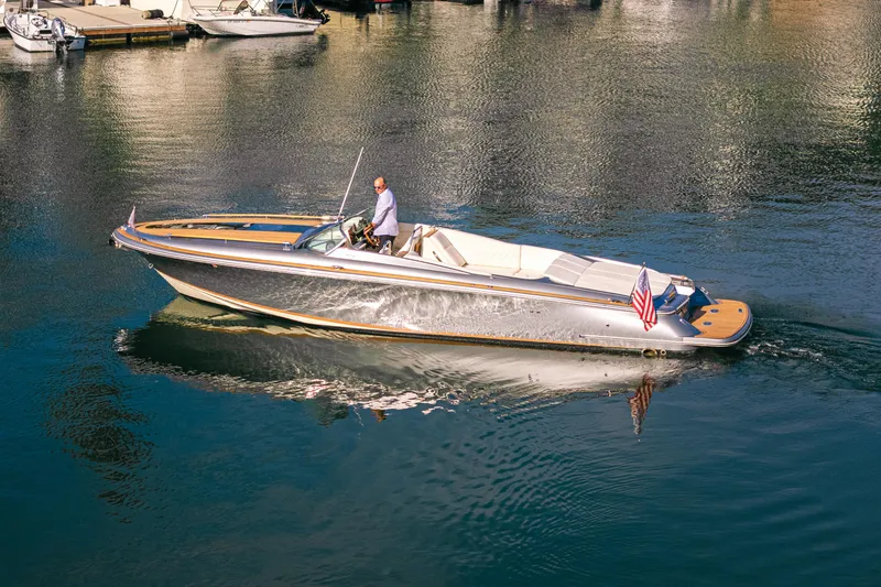 Slide: The Image of 2021 Chris-Craft Corsair 34 cruising on calm waters, showcasing sleek design and elegance. - 3