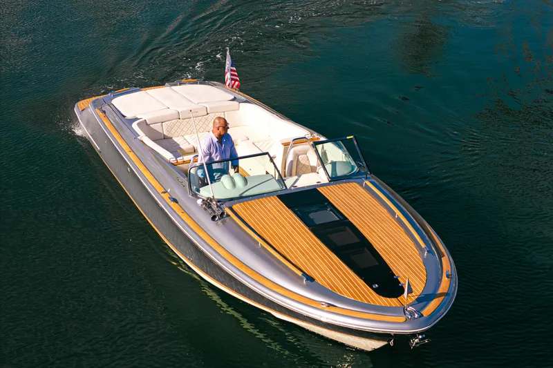 Slide: The Image of 2021 Chris-Craft Corsair 34 boat cruising on water, featuring elegant design and luxury seating. - 9