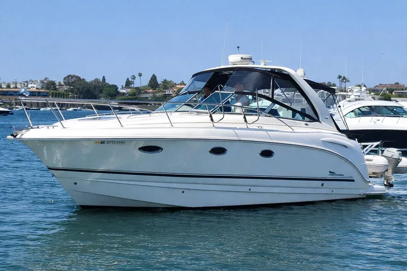 The Image of 2003 Chaparral 320 Signature boat cruising on a sunny day in a marina. - 0