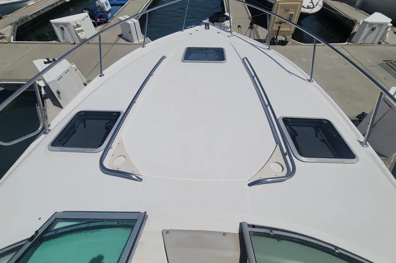 Slide: The Image of 2003 Chaparral 320 Signature yacht foredeck with hatches, docked at marina. - 17