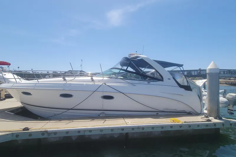Slide: The Image of 2003 Chaparral 320 Signature boat docked at marina under clear blue sky. - 20