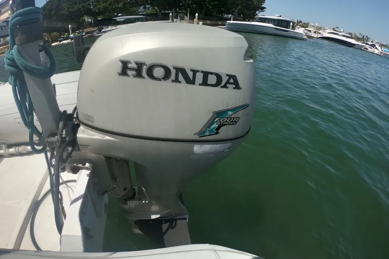 Slide: The Image of Outboard motor on a 2003 Chaparral 320 Signature boat, docked in a marina. - 21