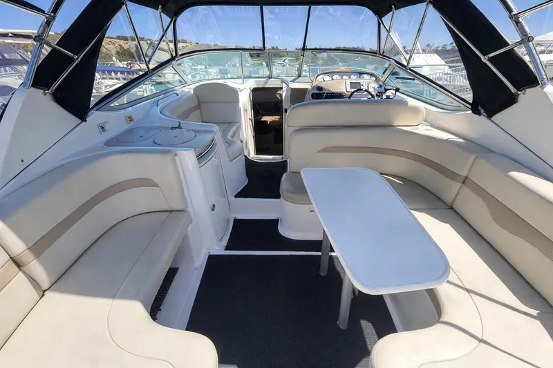 Slide: The Image of 2003 Chaparral 320 Signature boat interior with seating and table, showcasing luxury design. - 3