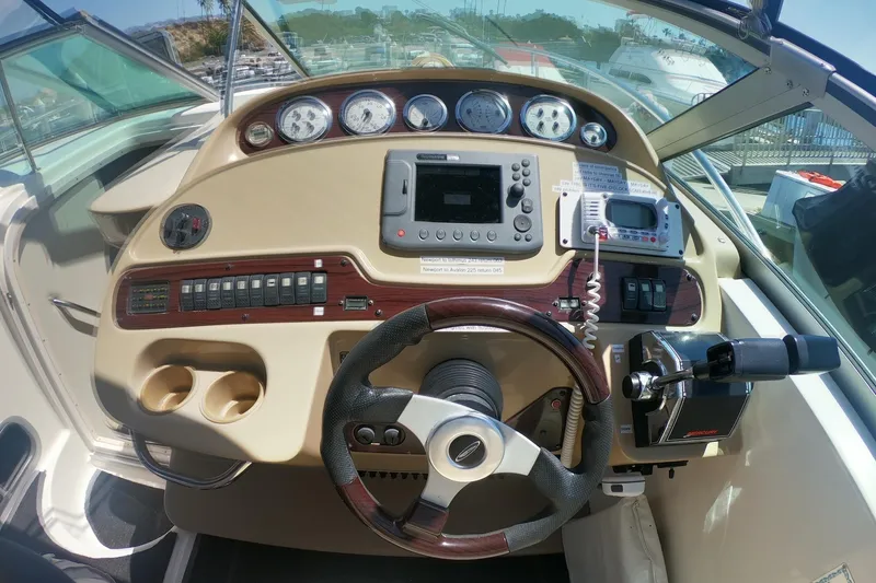 Slide: The Image of Helm of 2003 Chaparral 320 Signature boat with steering wheel, Radar/Chartplotter & control panel. - 4