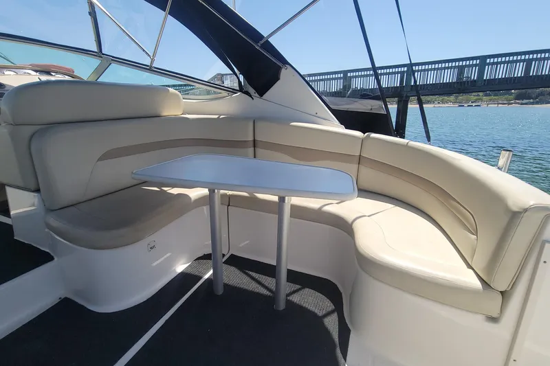 Slide: The Image of 2003 Chaparral 320 Signature boat interior with entertaining seating and table. Converts to Sunpad - 8