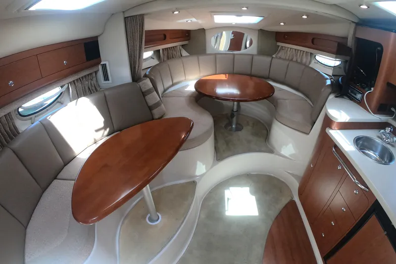 Slide: The Image of Interior of 2003 Chaparral 320 Signature yacht with elegant seating and solid Cherry wood tables. - 9
