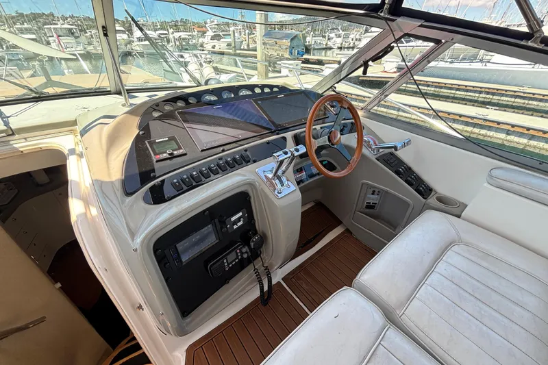 Slide: The Image of 1997 Maxum 4100 SCR yacht cockpit with steering wheel and control panel at marina. - 10