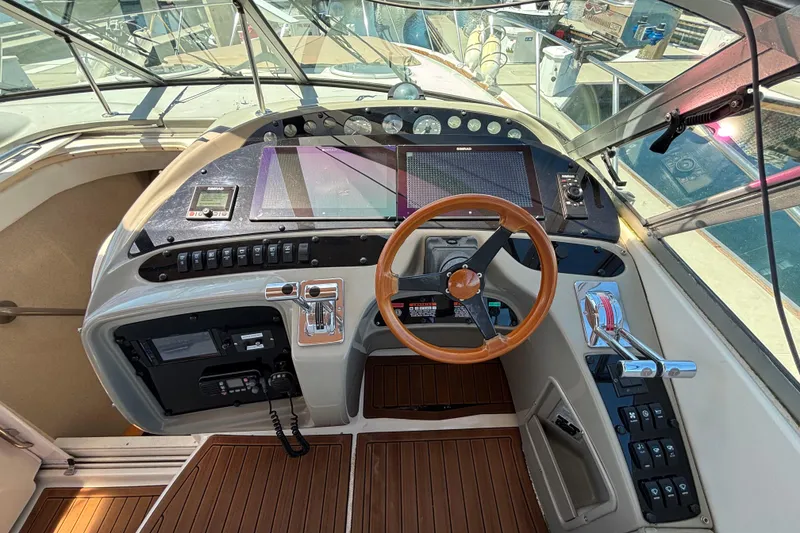 Slide: The Image of Cockpit of 1997 Maxum 4100 SCR yacht with wooden steering wheel and control panel. - 11