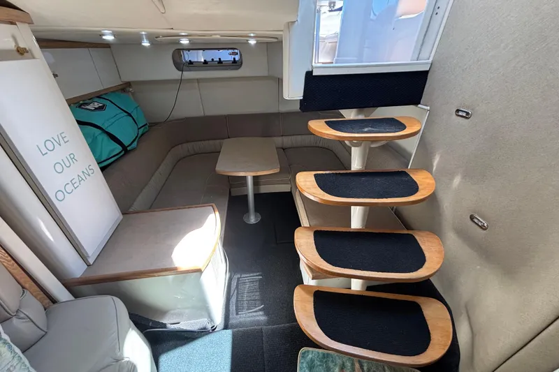 Slide: The Image of Interior of 1997 Maxum 4100 SCR yacht with cozy seating and stylish wooden steps. - 13