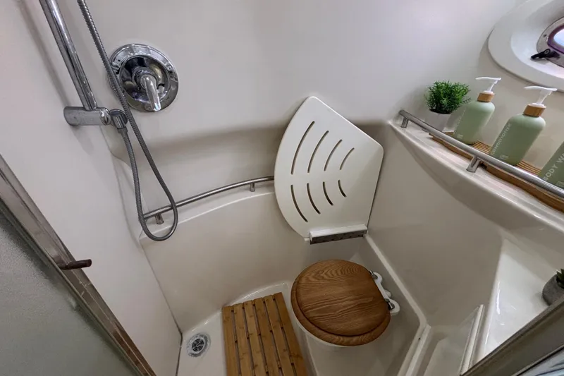 Slide: The Image of Compact bathroom in 1997 Maxum 4100 SCR yacht with shower and wooden seat. - 17