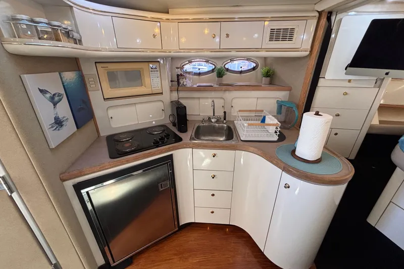 Slide: The Image of Luxurious 1997 Maxum 4100 SCR yacht kitchen with modern amenities and elegant design. - 18