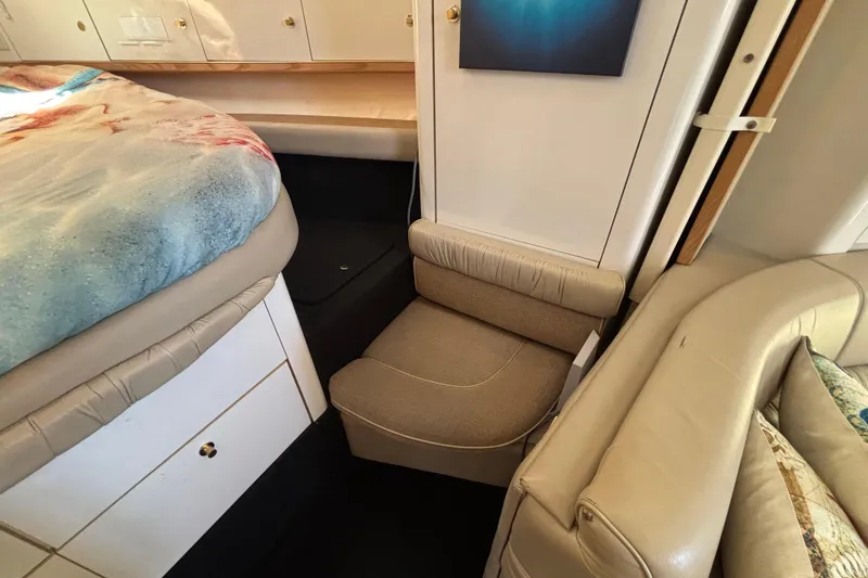 Slide: The Image of Interior of 1997 Maxum 4100 SCR yacht with cozy seating and storage. - 20