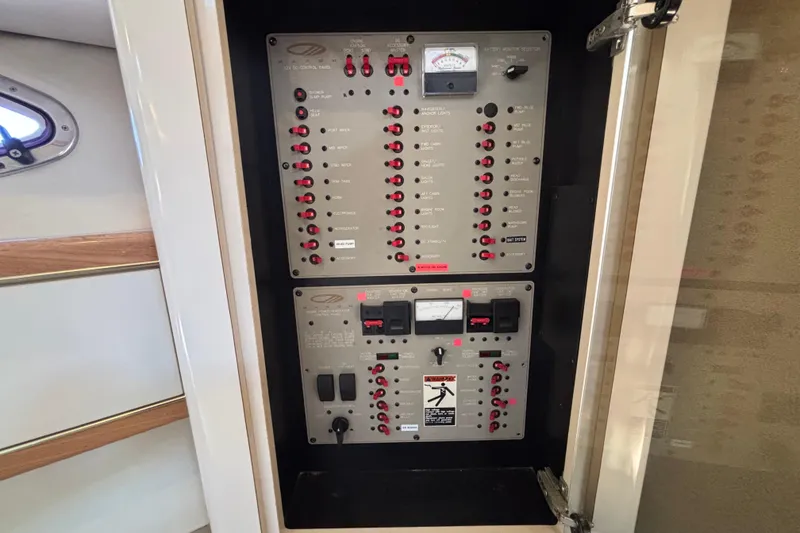 Slide: The Image of Electrical control panel on a 1997 Maxum 4100 SCR boat, featuring switches and gauges. - 22