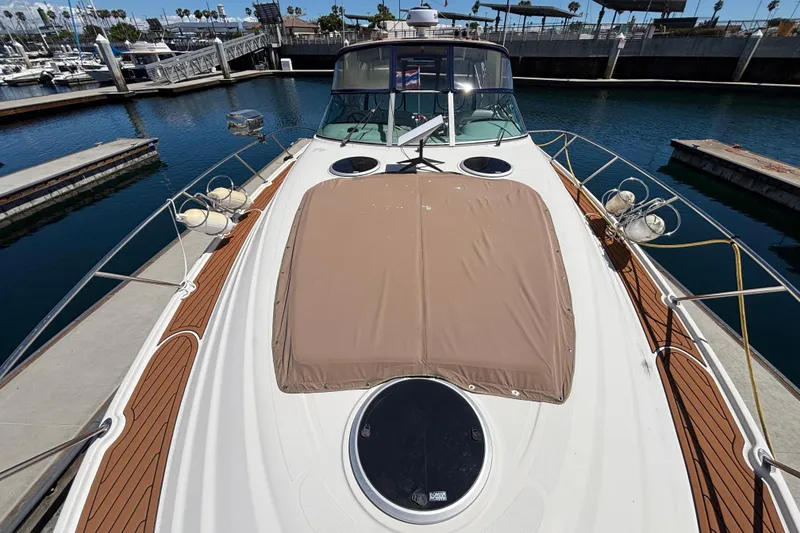 Slide: The Image of 1997 Maxum 4100 SCR yacht docked at marina, featuring sleek design and spacious deck. - 5