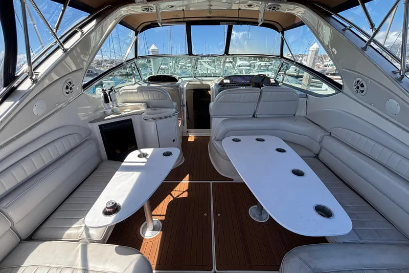 Slide: The Image of Luxurious interior of a 1997 Maxum 4100 SCR yacht with white seating and wooden flooring. - 6