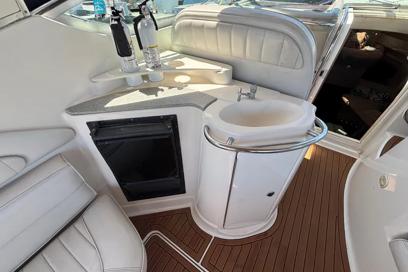Slide: The Image of Interior of 1997 Maxum 4100 SCR yacht with sink, fire extinguishers, and seating. - 7