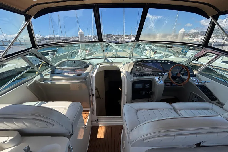 Slide: The Image of 1997 Maxum 4100 SCR yacht cockpit with leather seating and marina view. - 8