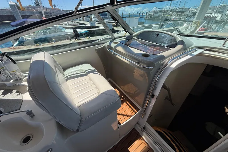 Slide: The Image of Interior of a 1997 Maxum 4100 SCR yacht with helm and seating area. - 9