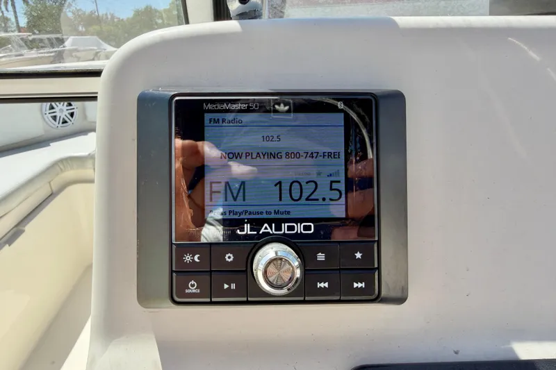 Slide: The Image of JL Audio MediaMaster 50 radio display on 2023 Cobia 220 Dual Console boat. - 15