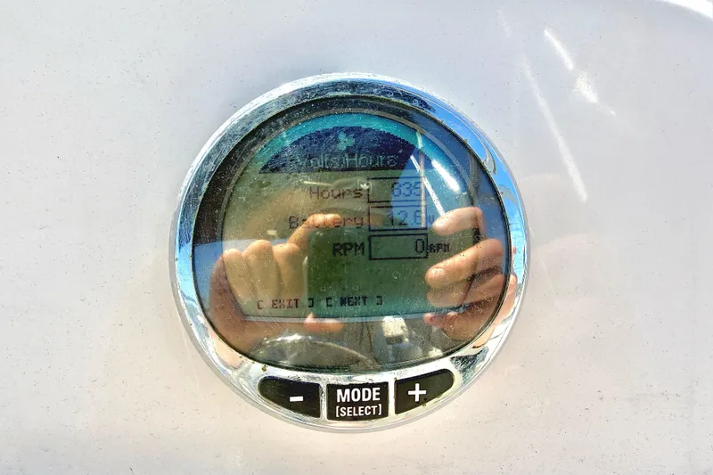 Slide: The Image of Digital display on 2023 Cobia 220 Dual Console boat dashboard showing engine hours. - 17