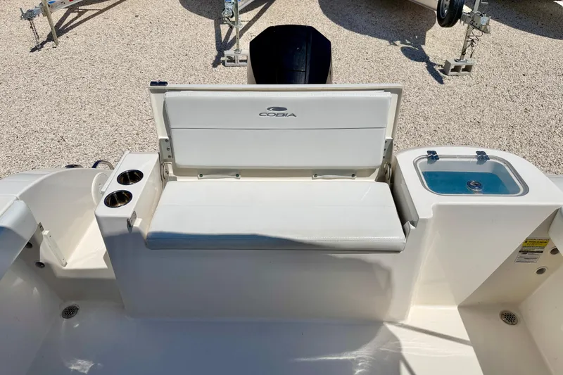 Slide: The Image of 2023 Cobia 220 Dual Console boat interior with seating and cup holders. - 24
