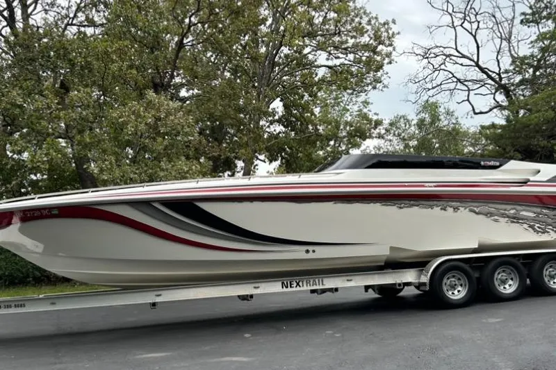 The Image of 2002 Fountain 38 Lightning boat on trailer, surrounded by trees. - 1